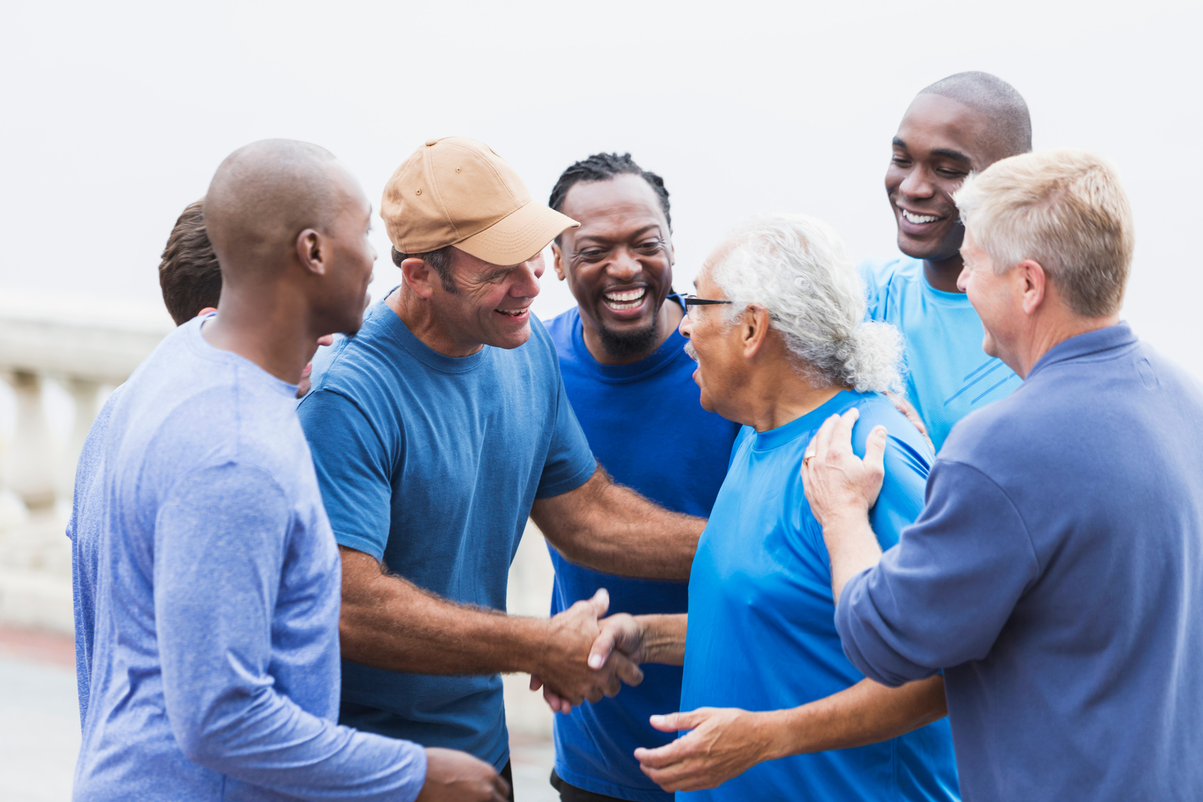 Multi-racial group of men,   shaking hands